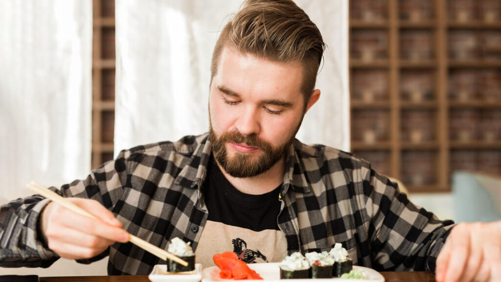 man eating sushi